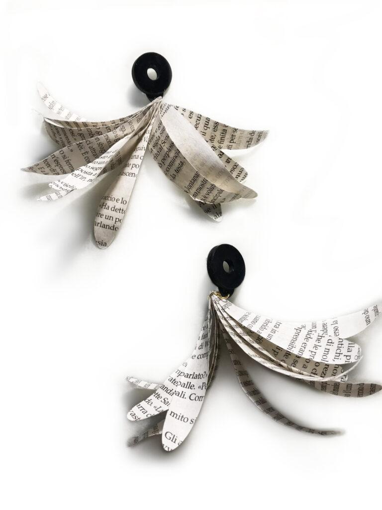 Long dangling stud earrings composed of feathers made of paper recycled from books