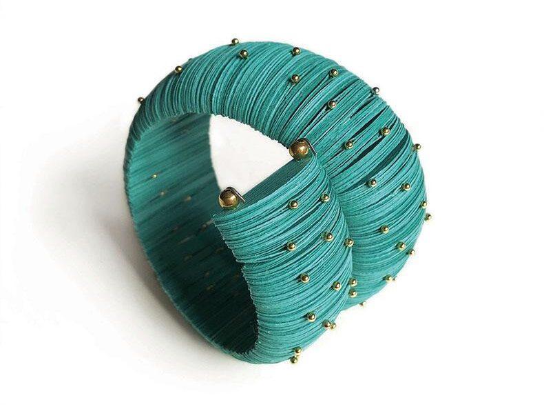 Elegant turquoise paper bracelet with small brass pins