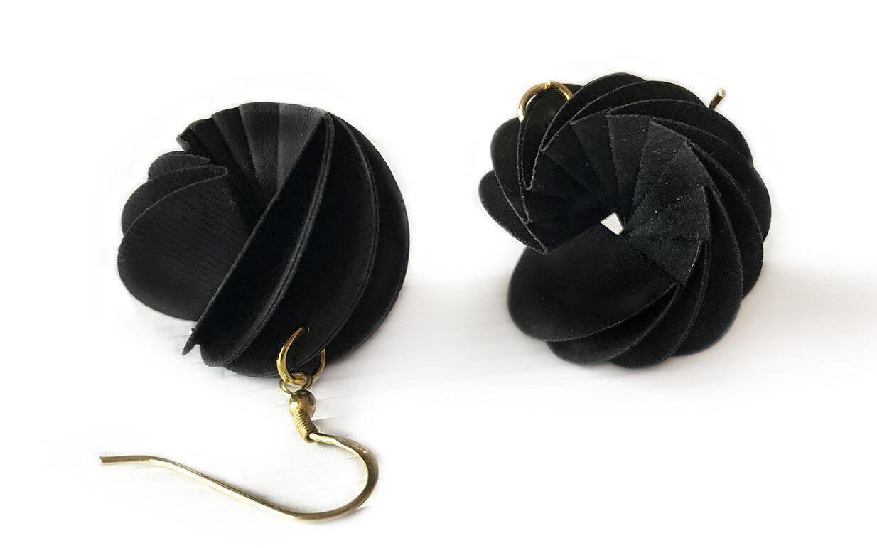 Christmas Gift Guide 2023, black dangling earrings in the shape of a spiral