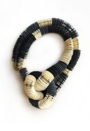Short necklace with central knot made of paper in three colors, black, white and dark gray